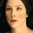 A pixelated image of a woman's face with dark hair and light skin, overlaid with 'The Lord of the Rings' text in gold lettering on black background.