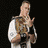 Animated sequence of a muscular man in various poses holding championship belts against black backgrounds.
