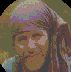 A circular pixelated image of a person with light purple headscarf and brown hair, wearing blue clothing against greenish background.