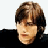 A pixelated image split into two sections: a person with brown hair and dark clothing on the left, and green text reading 'OriginalIcons.com' on a dark green background on the right.