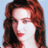 Static 48x48 pixel icon showing a close-up of a person with long red hair against a light blue background, rendered in low-resolution pixel art style.