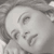 Static grayscale icon of a stylized human face with closed eyes and subtle facial features rendered in low-resolution pixel art style.