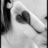A grayscale pixelated image shows a heart-shaped object with a stem, positioned on the right side of the frame against a light background.