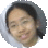 Two circular pixelated images of a person with dark hair and light skin, side-by-side, showing slight facial expression changes.