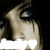 A pixelated close-up of a person's face with blue eyes and dark hair, showing two states: one with white horizontal blur across the mouth area and another without.