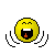 Pixelated yellow circular face with closed eyes, open mouth showing white teeth and red tongue, black outline, gray background.