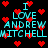 Pixelated cyan text reads "I LOVE ANDREW MITCHELL" over black background with red heart symbols, repeated in two vertical
