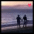 Two side-by-side animated frames of a beach scene with two silhouetted figures holding hands, featuring a heart symbol that changes color between frames.