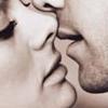 Two stylized faces in close proximity with lips touching, rendered in grayscale with smooth shading and minimal background detail.