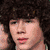 A four- shows a person with curly brown hair in various poses: close-up, arm raised, group shot, and blank
