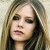 A pixelated image of a person with long light brown hair and dark eye makeup, next to bold black text reading "Don't Tell Me" on a beige background.