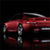 A red sedan with silver accents appears in a low-resolution pixelated image against a black background.