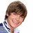 Pixelated image of a person with brown hair wearing a blue and white striped shirt, smiling against a white background.