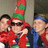 Three people in red and green holiday attire stand together on the left, while blue pixelated text reads 'Dark Bro Dynamite' on a green background to the right.