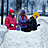 Animated sequence of three figures in winter gear interacting with snowdrifts against a blurred background.