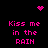 Black background with pink pixelated text reading "Kiss me in the RAIN" arranged in four quadrants, accompanied by a small heart and dot cluster icons.