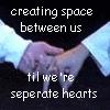 Two hands clasped in a handshake, with text overlay reading 'creating space between us til we're seprate hearts' on a dark background.