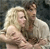 Static pixelated image of two people in close embrace with visible facial features and partial clothing details against a dark background.