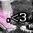 A pixelated image shows a character with pink hair and gray clothing, featuring a black square icon with white text '<3' on the left side.