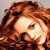 A pixelated image of a person with curly brown hair and light skin, next to green text on a dark background.