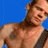 Animated contact sheet of a shirtless man with tattoos playing electric guitar against blue background, alternating between red asterisk symbols and live-action frames.