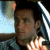 A pixelated image of a person with dark hair and light skin, wearing a striped shirt, next to green text reading 'Original Icons .com' on a solid background.