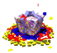 A pixelated 3D cube with a floral pattern sits atop a layered base of blue, red, and yellow shapes, surrounded by scattered yellow stars and small colored squares.