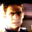 Pixelated static image of a person with light brown hair and dark clothing against a bright background, rendered in low-resolution style typical of early 2000s digital art.