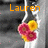 A static icon with orange text 'Lauren' above a cluster of pink and yellow flowers against a gray and black background.