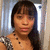 Pixelated image of a person with long dark hair and bangs, wearing a sleeveless top with visible shoulder straps.