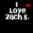 Four pixelated display 'I love zach s.' text with red heart symbols in various states of animation against a black background