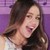A static pixelated image of a person with long brown hair against a purple background, wearing dark clothing.