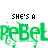 Pixelated text displays 'SHE'S A' above two side-by-side versions of the word 'ReBel', one green and one blue, with a gray top border.