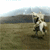 Animated sequence of a rider on a horse galloping across a grassy field under a cloudy sky, with the rider holding a flag.