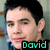Pixelated close-up of a person with dark hair and light skin, wearing a blue garment, with the name 'David' displayed in green text at bottom right.