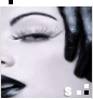 A close-up of a stylized face with closed eyes, black hair, and bold makeup including thick eyebrows and long eyelashes.