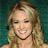 A pixelated image of a smiling woman with long blonde hair against a teal background, paired with bright pink text blocks reading "every happy ending's", "a new beginning", and "let yourself be enchanted".