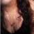 A woman with long dark hair and a black top is shown in three where her head moves slightly left to right