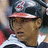A pixelated image shows a person wearing a dark cap with a red brim and a white-and-blue striped shirt, next to a red background with white text.