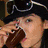 A person wearing a black hat with goggles and dark clothing holds chopsticks to eat waffles on a white plate, next to red background text.