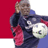 Pixelated static image of a person holding a soccer ball against red and white background with blue shoulder accent.
