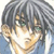 Pixelated close-up of a character with dark hair and light skin, wearing a blue garment against a light background.