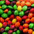 Pixelated image of colorful candy-like spheres with a white '<3' symbol on the right side.