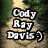 Pixelated text displays Cody Ray Davis and a date on a blurred outdoor path background with green foliage.