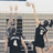 Pixelated image of two figures in black uniforms with white numbers on a sports court, overlaid with green text fragments on bright yellow background.