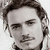 Two grayscale portraits of a man with styled hair and mustache appear on the left, while the right side displays pixelated text on green background.