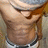 Pixelated close-up of a person's torso with visible abdominal muscles, wearing dark shorts and a light-colored top.