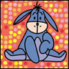 Blue cartoon donkey with long ears sits cross-legged on a polka-dot background, holding a heart-shaped object.