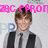 Pixelated image of a person with brown hair wearing a light shirt and dark tie, overlaid with pink text reading 'ZAC EFRON' at the top.