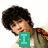 A person with dark curly hair wears a gray shirt over white, holding green icons displaying 'I', 'L', and 'Y!' in sequence.